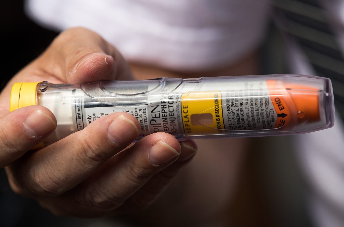 NEW YORK, NY - AUGUST 30: Timothy Lunceford Stevens, who suffers from autoimmune diseases and allergies, holds an EpiPen as he speaks to reporters during a protest against the price of EpiPens, outside the office of hedge fund manager John Paulson, August 30, 2016 in New York City. Paulson's hedge fund is a major investor in Mylan, the pharmaceutical company who has raised the price of EpiPens over 400 percent in the past 8 years. Mylan announced on Monday they will start offering a generic version of EpiPen, which will cost about half the price of the 600 dollar brand name version. (Photo by Drew Angerer/Getty Images)