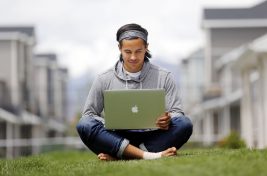 Garrett Gee works on his laptop outside his home in Vineyard, Wednesday, May 20, 2015.